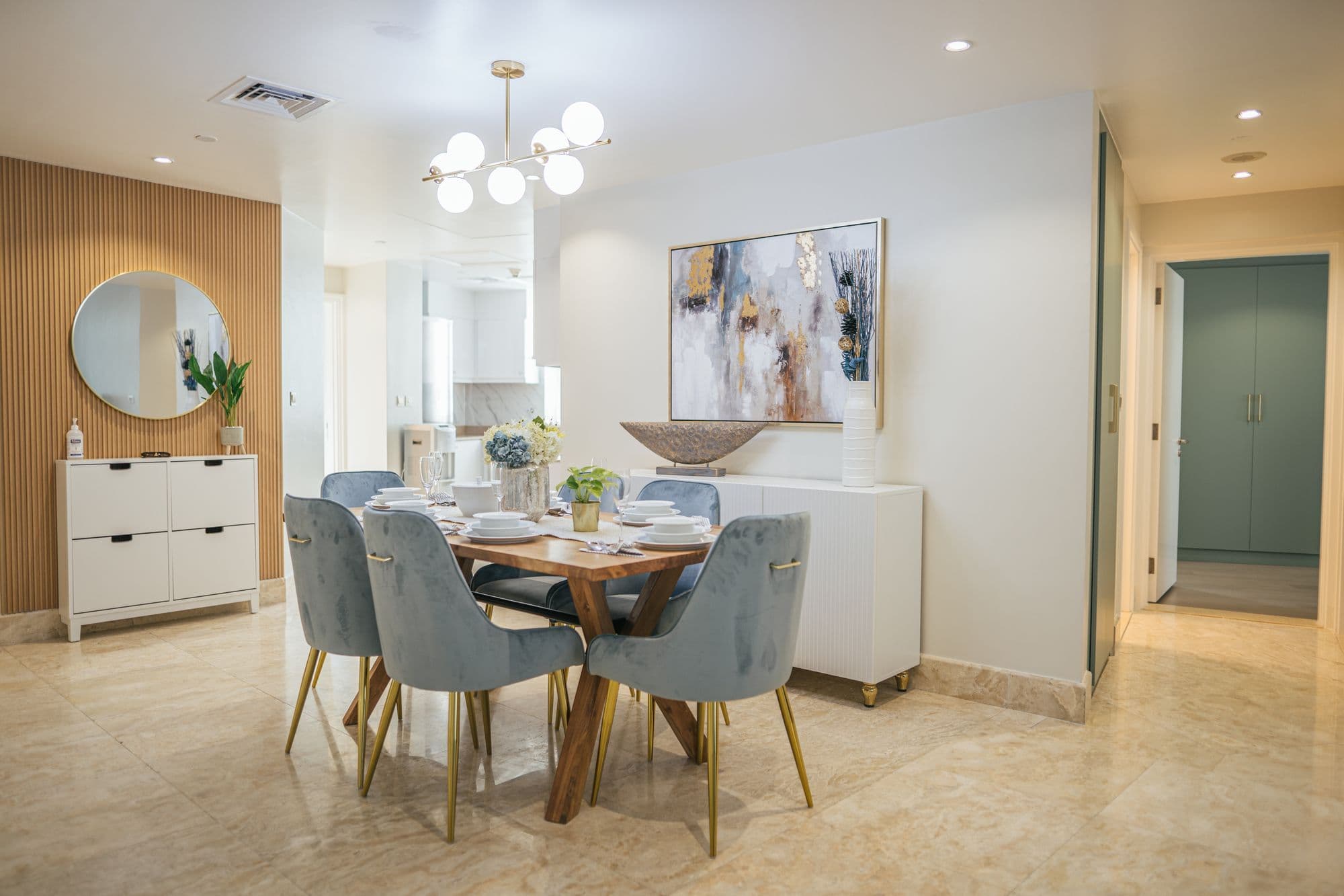 Dining room with a round mirror and console